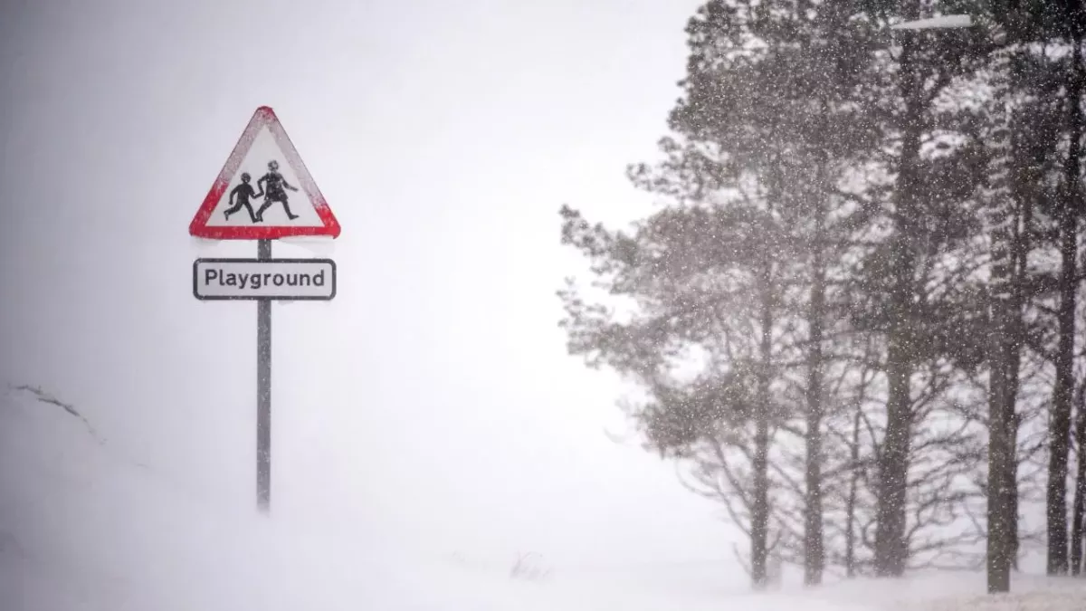 School sign engulfed in snow