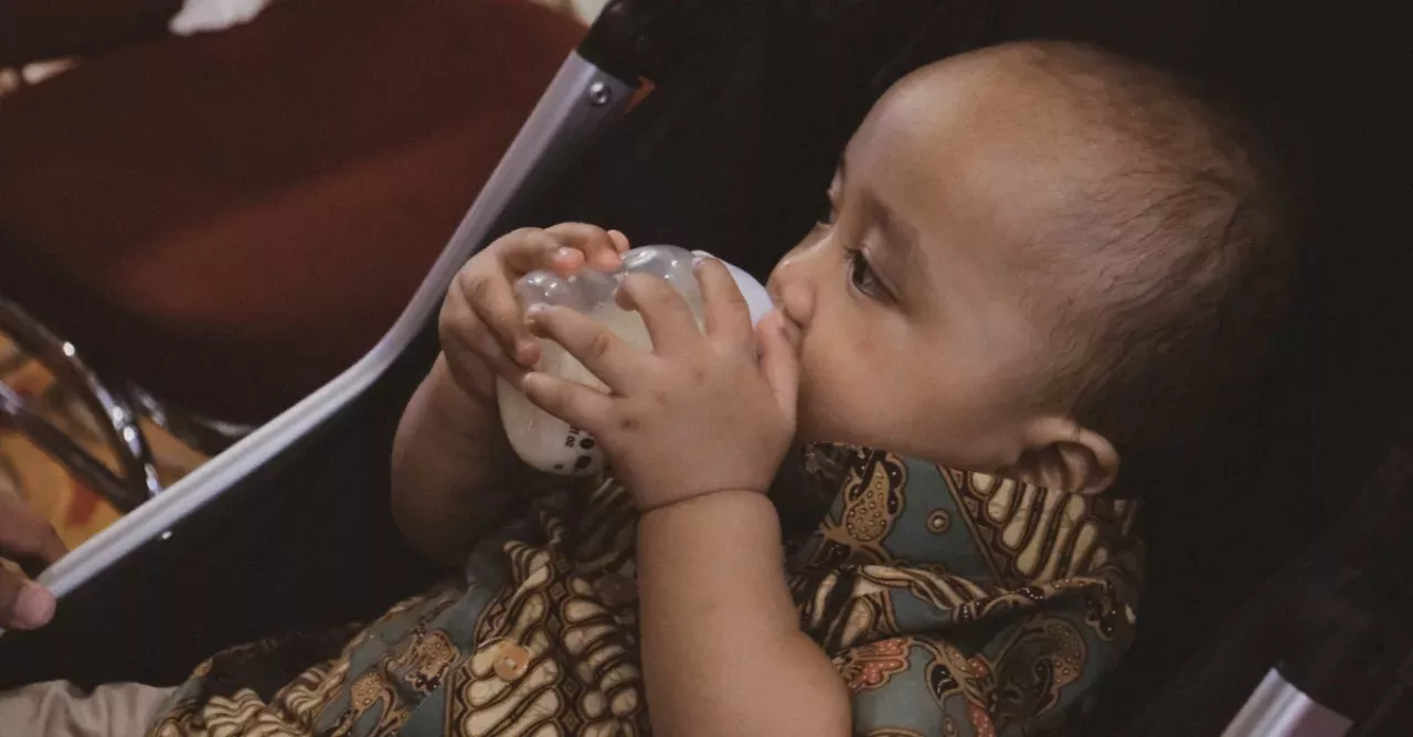 A baby drinks coffee instead of milk